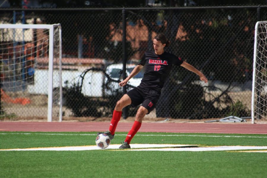 Senior defender Jake Munivez controls the ball against his opponents.  