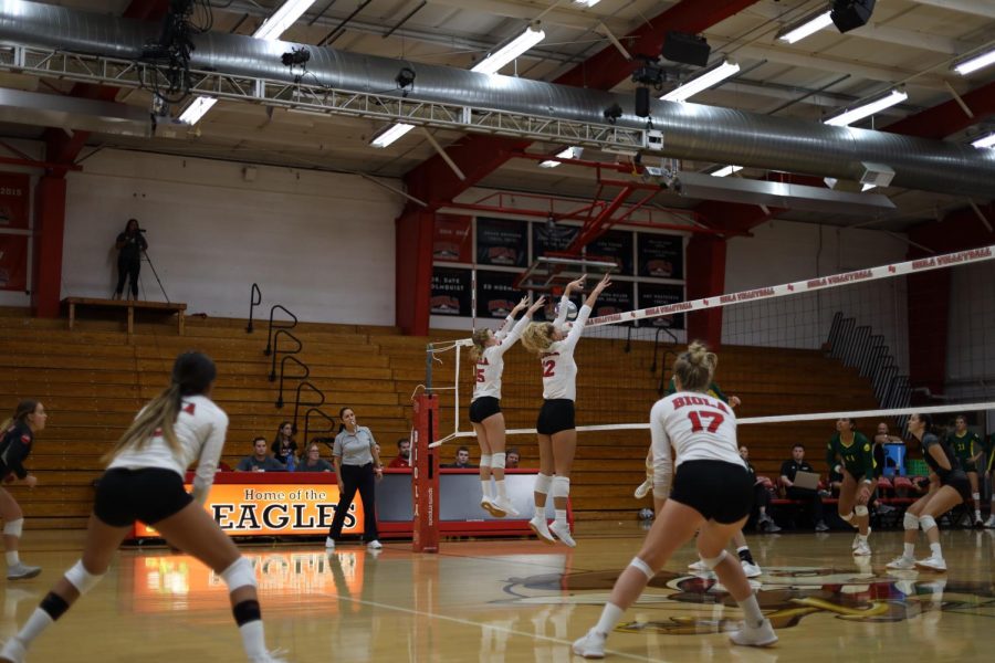 Freshman+Abigail+Copeland+and+Senior+Becca+Branch+jump+for+the+ball.+