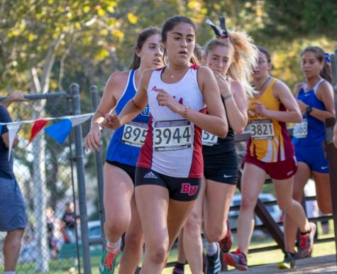 Biola cross country runner runs ahead of her opponents. 