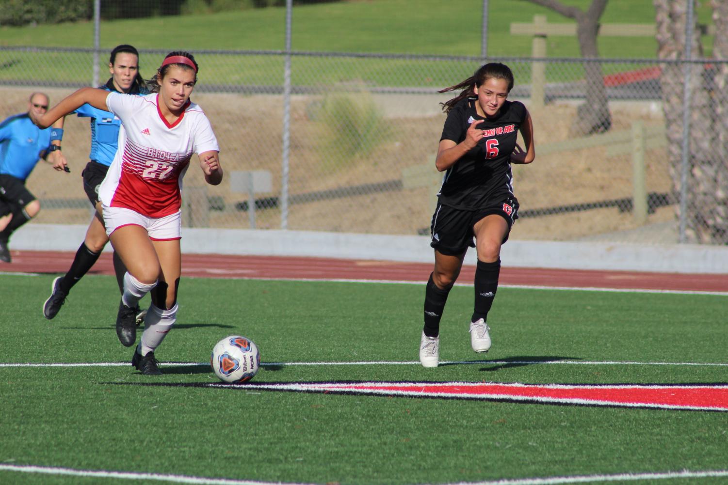 Senior Forward Annmarie Alvarez dribbles the ball down the field. 