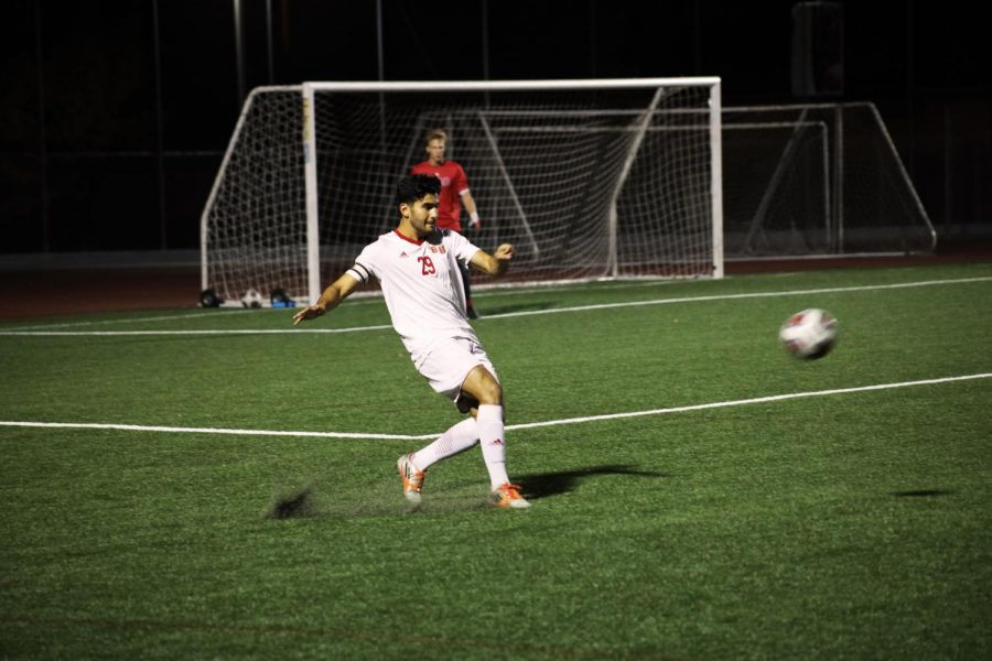 Senior defender, Alejandro Pelayo, kicks the ball away from the Biola goal.