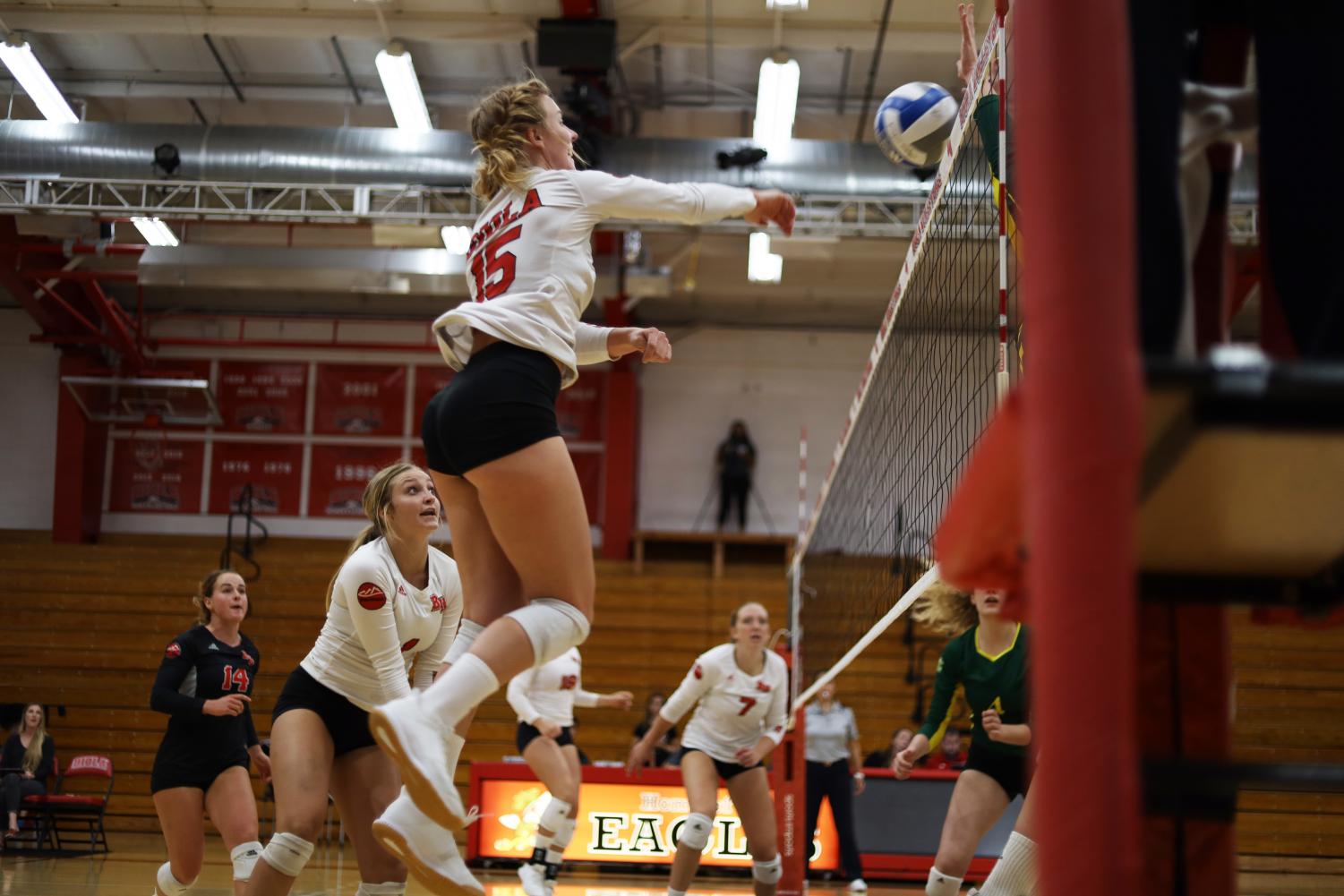 Senior outside hitter Becca Branch hits the ball over the net. 