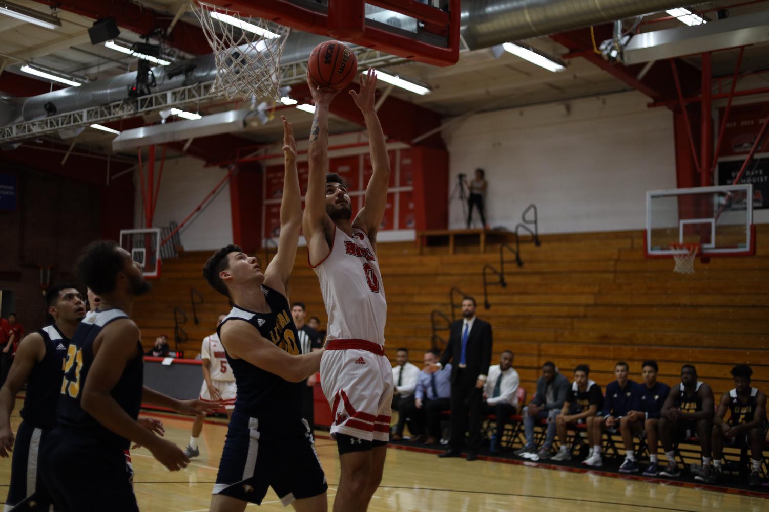 Junior guard Michael Bagatourian jumps to make a basket. 