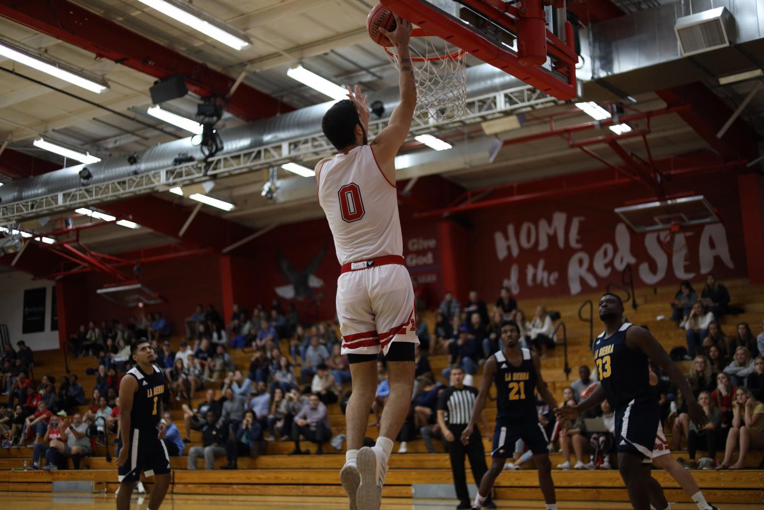 Junior guard Michael Bagatourian dunks the ball into the net. 