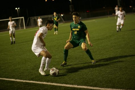 Sophomore forward Hann Kim dribbles the ball around his opponent from Point Loma Nazarene University on November 13th 2019. 