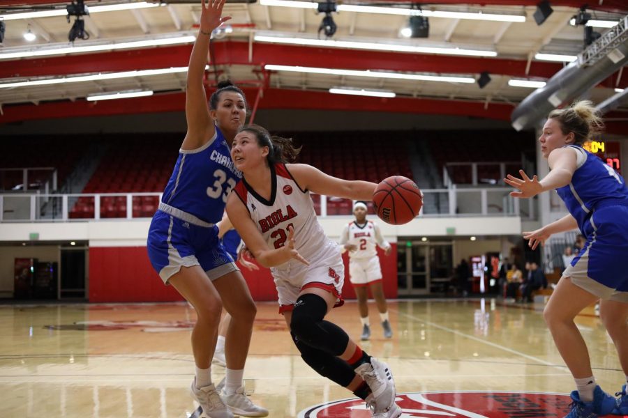 Freshman forward Madi Chang dribbles the ball around her opponent from Chaminade University on February 13th, 2020.  