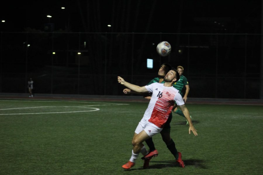 Midfielder Daniel Simonis fights for the ball during Biola's game against CUI. 