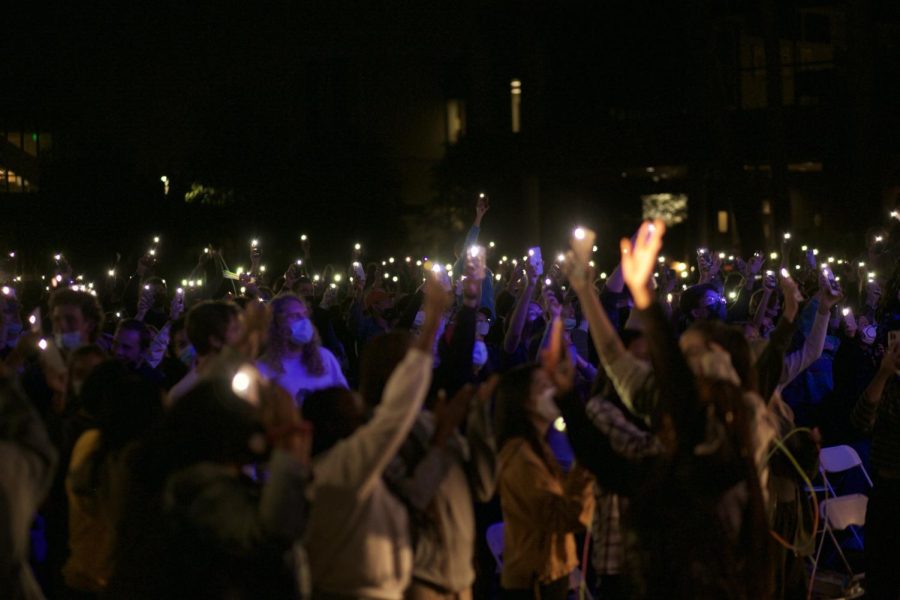 Students put up lights during worship at session two of the 2021 Torrey Conference. 
