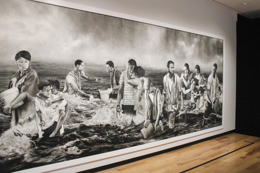 This larger-than-life charcoal and graphite on paper piece serves as the centerpiece to the Sea We Must Wade exhibit. Created by Shawn Michael Warren, the piece “was created as a response to the water crisis in Flint, MI.” 