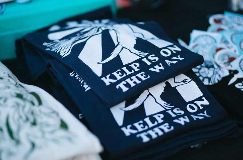 T-shirts with conservation slogans sit at a booth.