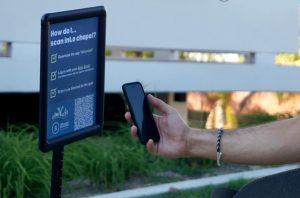 A chapel attendee scans a QR code to download the iAttended app