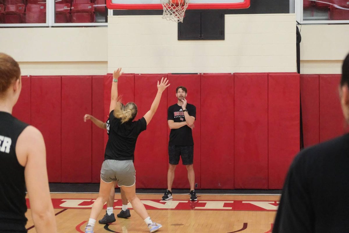 Coach Simo pictured middle coaching Biola women’s basketball