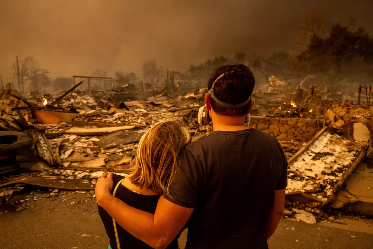 Couple takes in the devastation of their burnt home after fire destroys it, taken on Jan. 8. 
