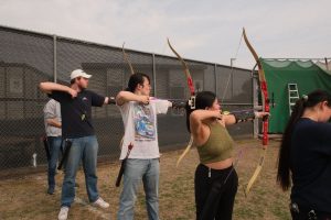 Students taking an archery class shoot at the range. Many of the students in the class are also part of the archery club to further their skills. 
