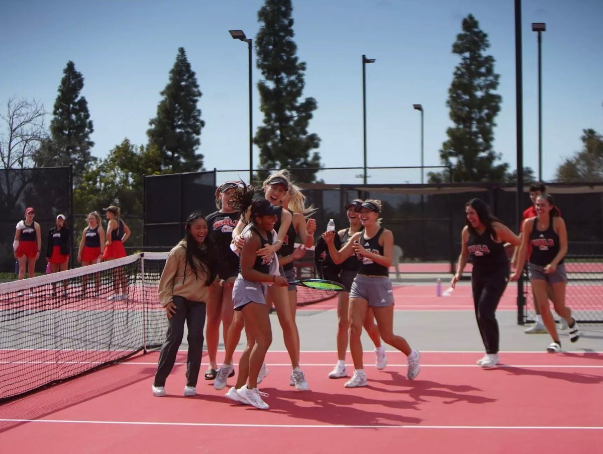 Biola’s women’s tennis team celebrates during a game against MSU Denver on March 16, 2024. 