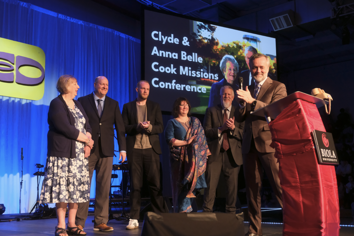 President Barry Corey (far right) announces the renaming of Missions Conference and honors the Cook family onstage on Mar. 19, 2025. Pictured left to right: Laura Botka, Ken Botka, Tyler Botka, Jamie Cook, Craig Cook, President Barry Corey
