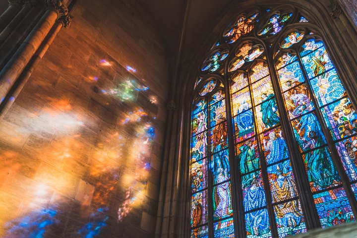 Stained Glass window in a Cathedral with religious imagery.