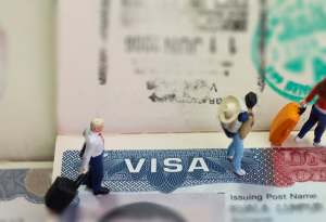 A photo of visa documentation with miniature travelers.